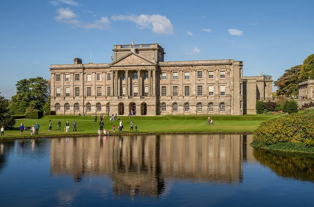 Lyme Park house reflected in the lake beside its formal gardens