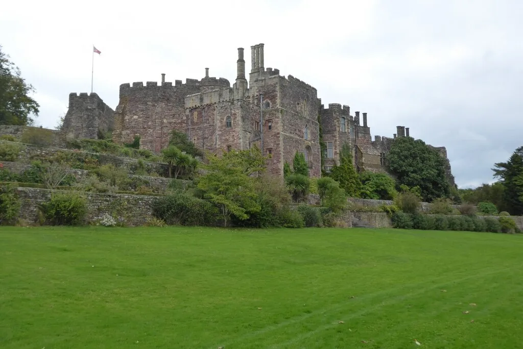 Berkeley Castle’s pink-grey stone walls and towers above a lawn