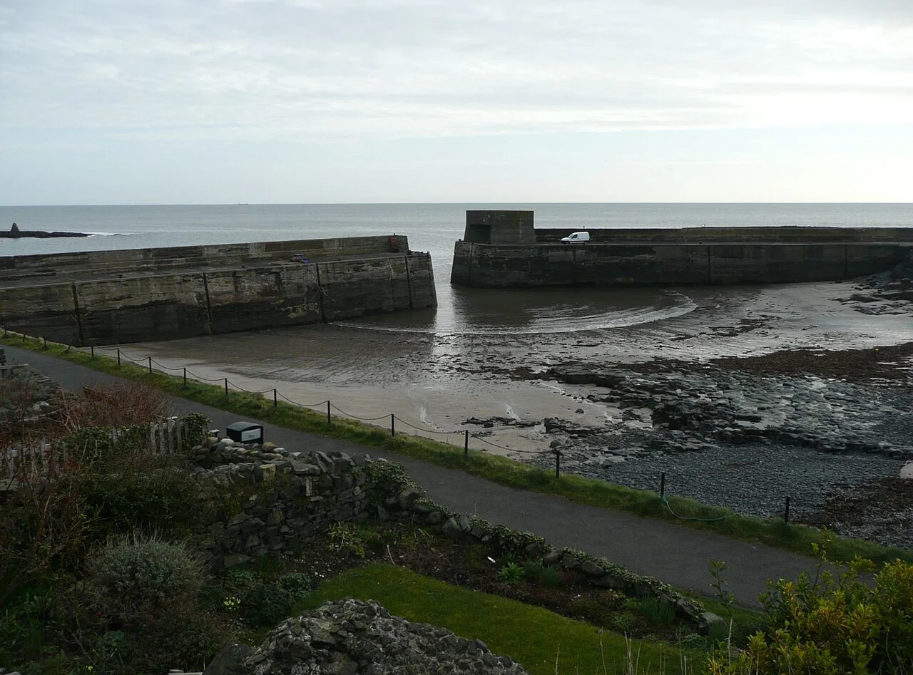 Stone harbour walls enclosing the water at Craster