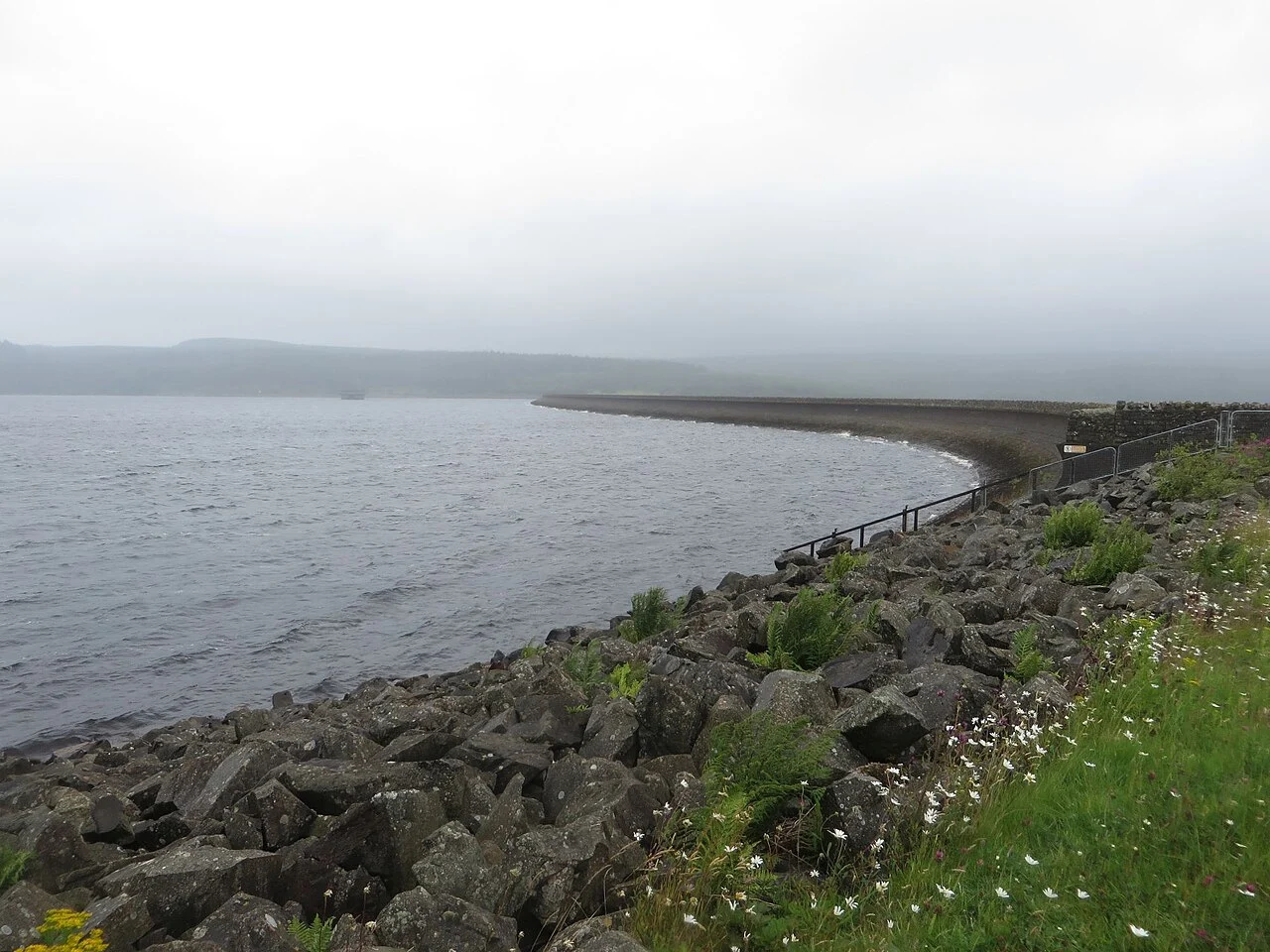 Kielder Water beside the stone and concrete edge of its dam