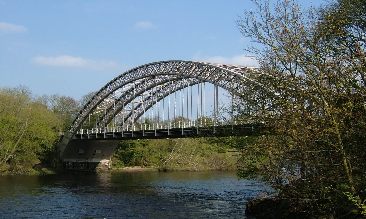 The arched iron structure of Hagg Bank Bridge above the River Tyne